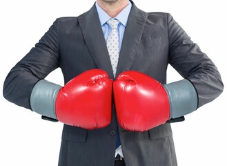 Businessman in gray suit with boxing gloves
