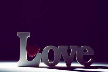Word love and red heart on floor