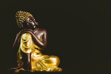 Buddha statue over black background