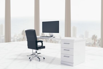 Flat design office is showing white desk with monitor and black swivel chair, with coastal view
