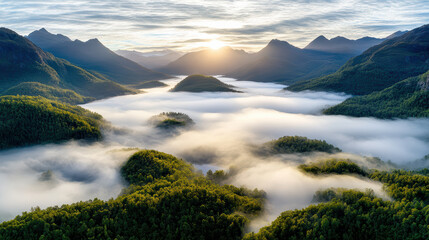 Misty aerial landscape with mountains in silhouette, showcasing serene valley enveloped in fog