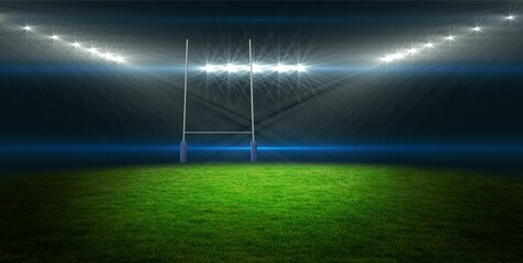 Flat design rugby goalposts with padded bases are standing on grassy pitch under bright floodlights