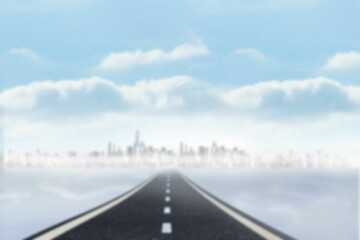 Empty road towards skyscrapers