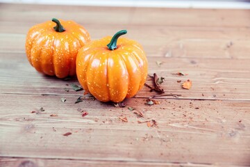 Two orange pumpkins on table