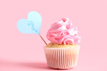 Delicious cupcake with question mark on color background. Gender reveal party concept
