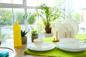 Set of different clean dishes on table in kitchen