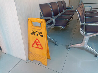 a warning that says caution slippery wet floor