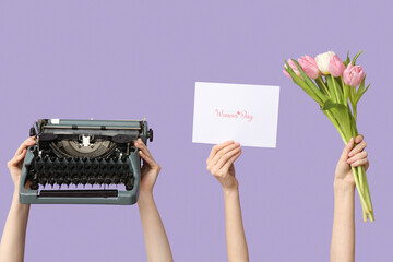 Female hands with retro typewriter, greeting card and tulip flowers for International Women's Day...
