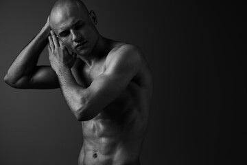 A contemplative man poses in black and white, portraying vulnerability and strength, showcasing...