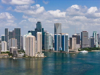 Fototapeta premium Aerial view of Brickell skyscrapers. Modern cityscape of downtown Miami. Panoramic Miamis skyline above the coastline. Brickell Key aerial view in Miami. Landscape of Miami. Miami Beach and Brickell.