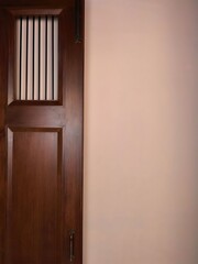 Traditional wooden door with privacy slats beside a plain wall.