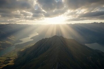 Majestic mountain peak bathed in golden sunlight.  Vast landscape with a serene lake nestled amidst the peaks.  A breathtaking view of nature's grandeur