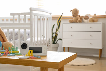Baby monitor with building blocks on table in children's bedroom, closeup