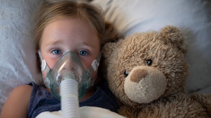 Young caucasian female child with oxygen mask and teddy bear in hospital bed