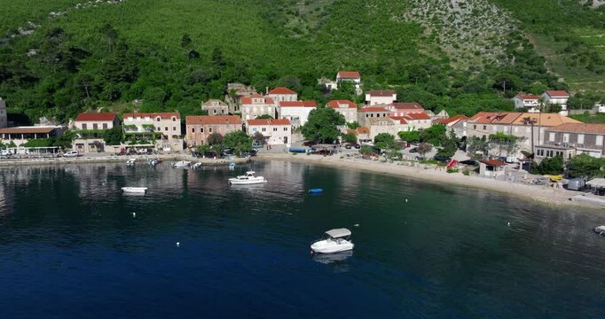 Boats Floating In The Sea By Trstenik Village in Peljesac Peninsula, Croatia. - aerial shot