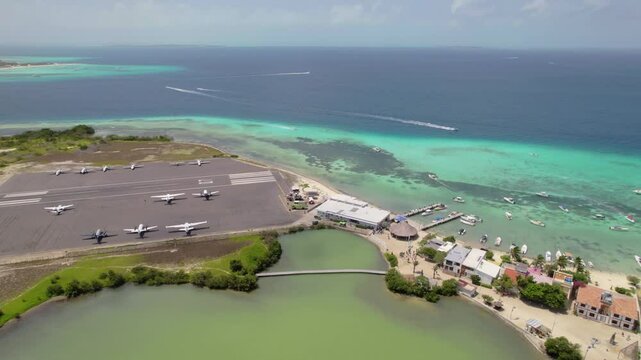 Boats sailing fast in clear turquoise waters leaving trail on water, Los Roques Airport