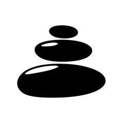 Black stones stacked carefully on top of each other in a zen style