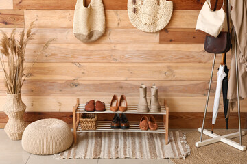 Shoes stand and hanger in interior of hallway