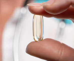 Health professional demonstrating a nutritional supplement capsule in a clinical setting