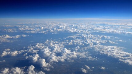 Fototapeta premium Expansive aerial view of cloudscape overlapping earth below