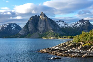 Beautiful rocky coastal landscape at Ardenes in Vesteralen, Norway, with snowcapped mountains