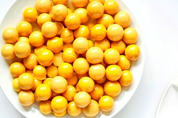 egg yoke fudge balls cooked in syrup on background