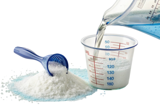 Laundry detergent powder being measured with scoop and jug isolated on transparent background