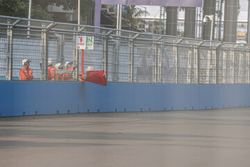Marshals raise the red flag during a racing championship
