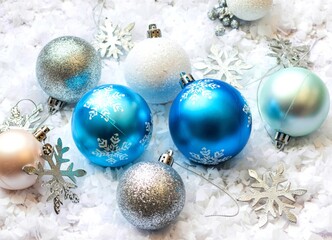 Christmas decorations white Christmas balls and snowflakes on soft snow, copy space