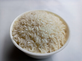 close up bowl of jasmine rice grain isolated on white background