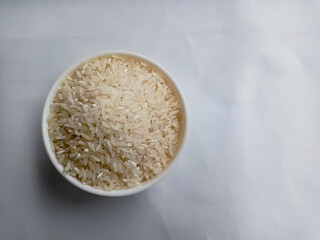 close up bowl of jasmine rice grain isolated on white background