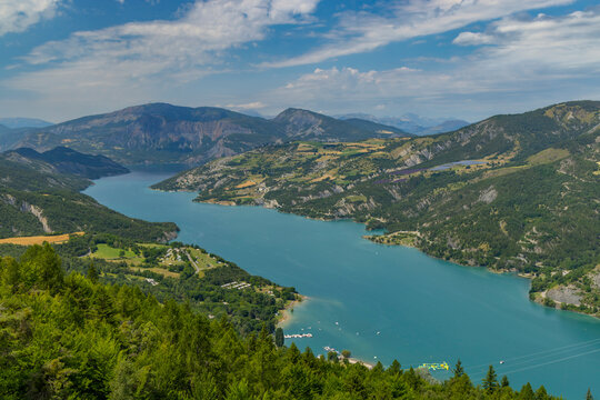 Serre Poncon Lake Embraced by Lush Green Mountains in French Alps under Summer Sky