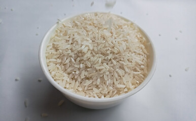 close up bowl of jasmine rice grain isolated on white background