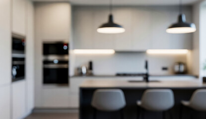 Blurred kitchen interior with counter stools black fixtures and white cabinets.