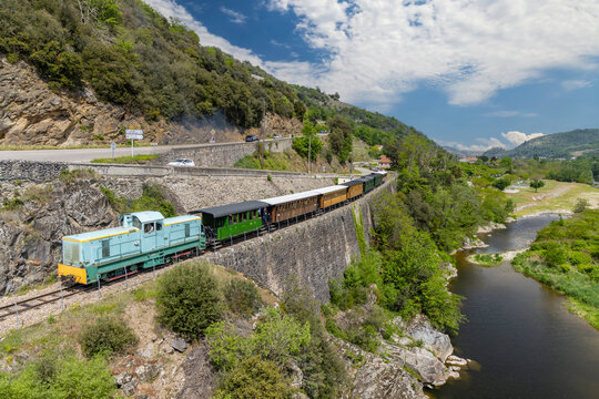 Train running along the Doux Gorges in Saint Jean de Muzols, Ardeche, France