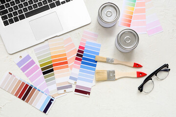 Painter's supplies with laptop on white grunge background
