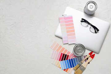 Painter's supplies with laptop on white grunge background