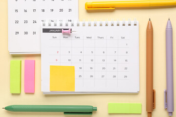 Calendars with office stationery on yellow background