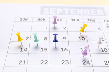 Calendar with paper pins, closeup