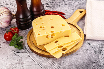 Maasdam cheese piece with slices