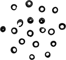 A collection of small black rubber washers arranged in a scattered pattern.