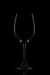 Minimalist wine glass isolated on black background with soft rim lighting