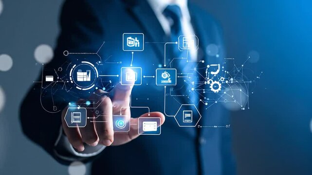 A person in a suit interacts with a digital interface displaying interconnected data elements, including graphs, icons, and gears, suggesting a workflow or process visualized through technology - Powered by Adobe
