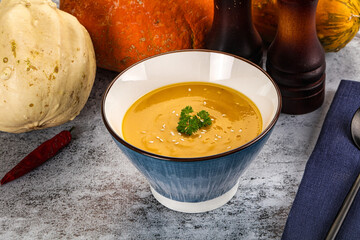 Vegan pumpkin cream soup served sesam
