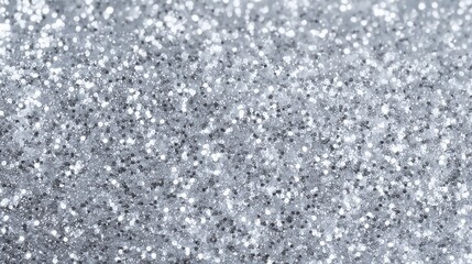 Fototapeta premium Close-up of sparkling silver glitter texture with shimmering highlights