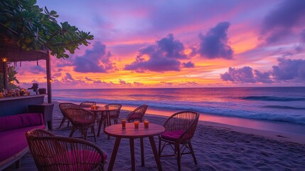 Beachfront caf&eacute; at sunset with vibrant sky and ocean waves