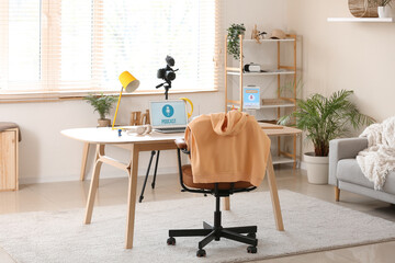 Interior of podcaster's studio with workplace, shelf unit and plants