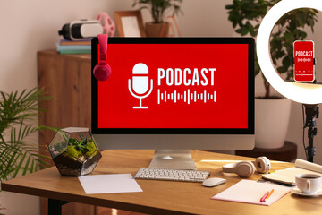 Podcaster's workplace with gadgets and glowing ring light in studio