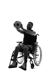 Fototapeta premium Silhouette of sporty young man in wheelchair with soccer ball on white background