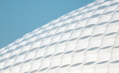 A white building with a blue sky in the background